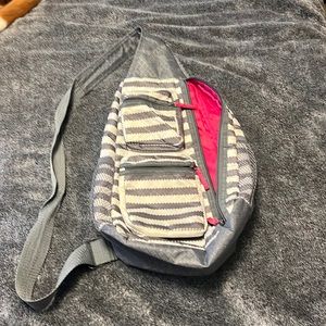 Thirty-One Cross body sling back bag, gray and white striped used condition.